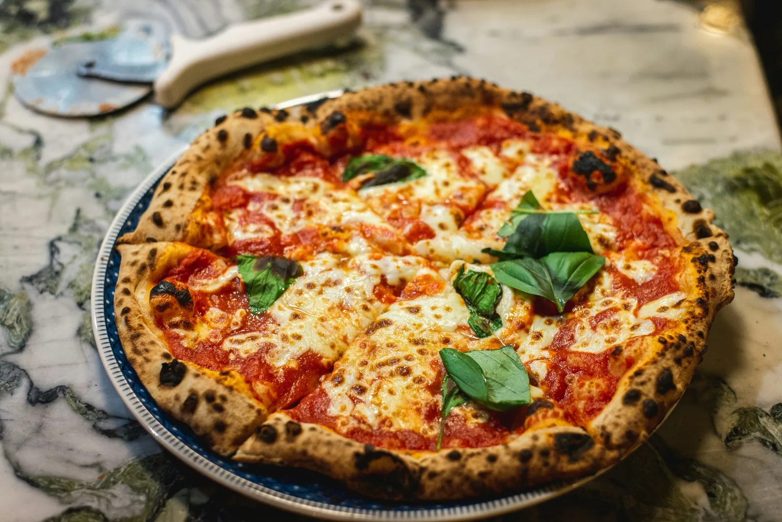 Perfectly charred pizza crust with fresh toppings